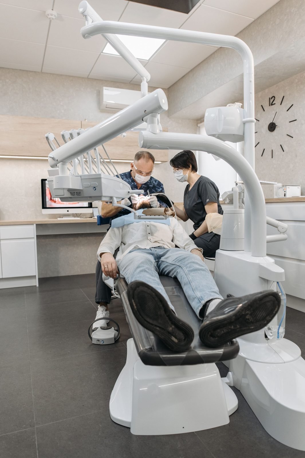 A dentist preparing the treatment room before an appointment.